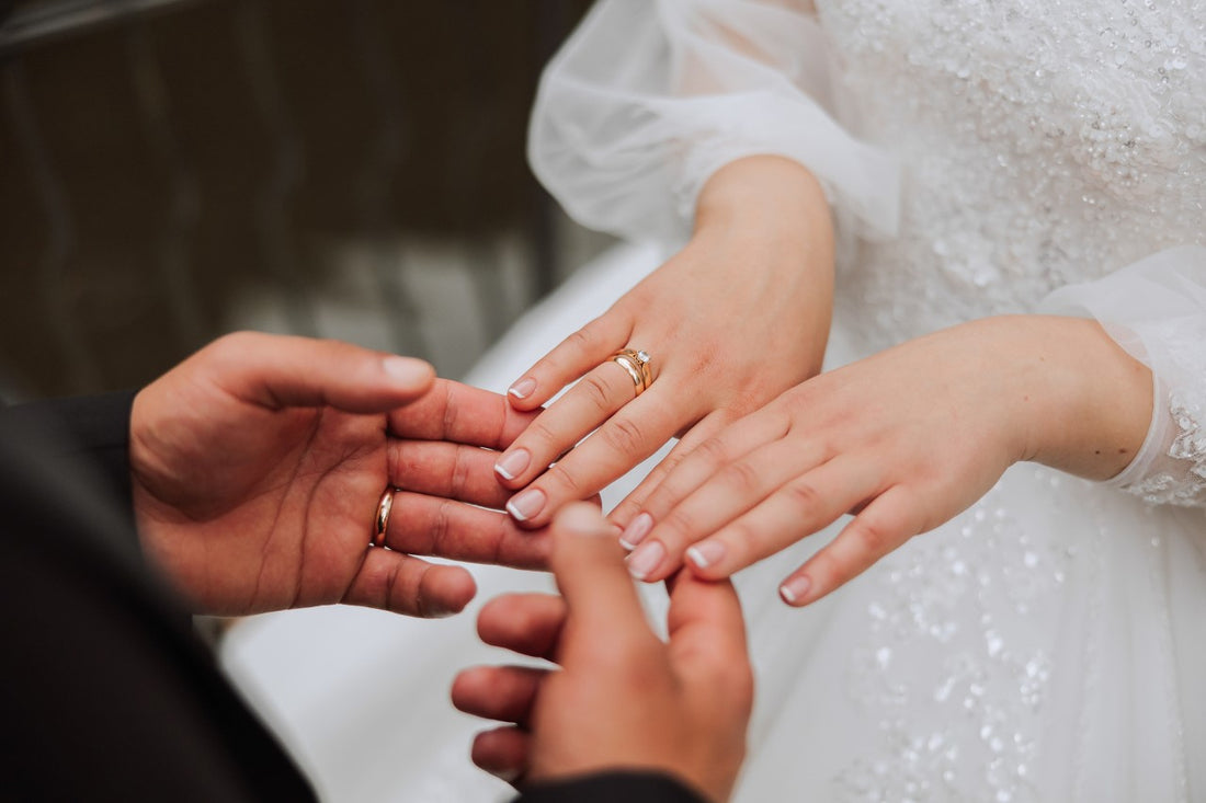 The groom holds the bride's hand.